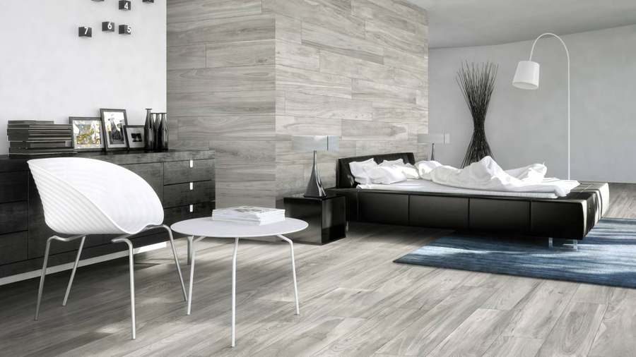 Dormitorio con suelo de porcelánico imitación madera gris en lamas largas de vetas distintas